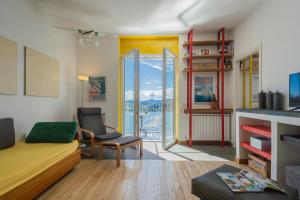 a living room with a couch and a chair at Casa Corbu by Rent All Como in Blevio
