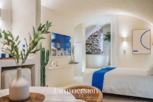 a hotel room with a bed and a fireplace at Hélios, Suite Grecque & Spa in Vienne