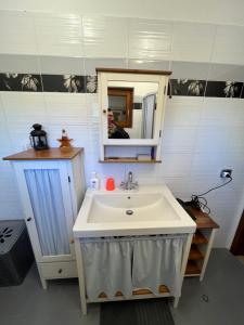 a bathroom with a sink and a mirror at Appartamento Falesia del Neirone in Gavi +25 photos
