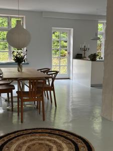 a dining room and kitchen with a table and chairs at Beautiful Villa in Klampenborg in Klampenborg +15 photos