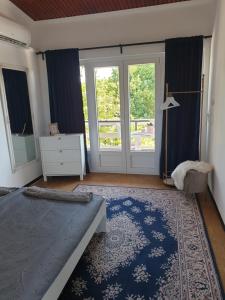 a bedroom with a bed and a large window at Simay Apartman II in Balatonalmádi