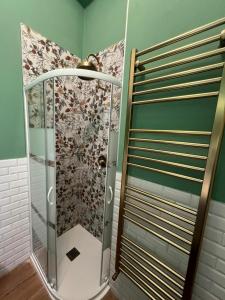 a shower with a glass door in a bathroom at Stresa Golf & Relax Romantik Suite in Gignese