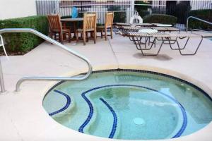 a jacuzzi bath tub with a table and chairs at Old Town Southwest Style 2BR Condo with Pool and Hot Tub in Scottsdale