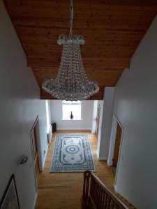 an overhead view of a hallway with a chandelier at Crowe's Bridge House in Quilty