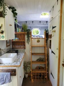 a small bathroom with a sink and a counter at Monroe Horsebox Glamping in Porthleven