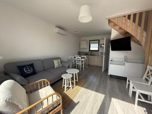 a small living room with a couch and a kitchen at Domki Białe Żagle in Władysławowo