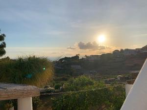 a view of the sunset from the balcony of a house at House La Pennata - sea view in Malfa +20 photos