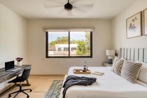 a bedroom with a bed and a desk and a window at Group Apt 13 16, no view, 3BR, 12 pax in Cabo San Lucas +36 photos