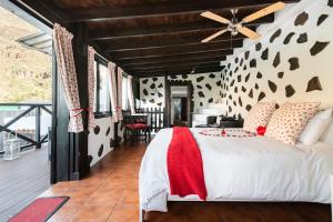 a bedroom with a bed and a ceiling fan at Angels Pathway in Fátaga
