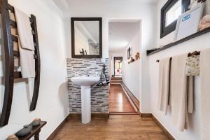 a bathroom with a sink and a brick wall at Angels Pathway in Fátaga +51 photos