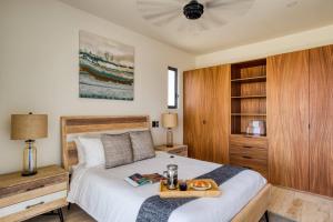 a bedroom with a bed with a tray of food on it at Family Friendly APT 17 ocean view, 3BR, 6 pax in San José del Cabo +21 photos