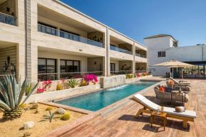 a house with a swimming pool next to a building at Family Friendly APT 17 ocean view, 3BR, 6 pax in San José del Cabo