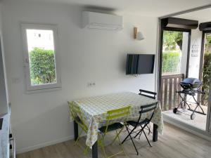 a table and chairs in a room with a balcony at Studio Argelès sur Mer in Argelès-sur-Mer