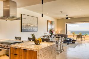 a kitchen and dining room with a view of the ocean at For couples, petfriendly 2 BR ocean view 18 4pax in Cabo San Lucas