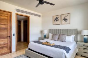 a bedroom with a bed with a tray on it at For couples, petfriendly 2 BR ocean view 18 4pax in Cabo San Lucas +24 photos