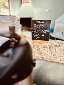 a kitchen counter with a chalkboard on a counter top at Vila Bardot in Barra do Sahy +41 photos