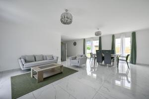 a living room with a couch and chairs and a table at Casa di Luce - Garden - 9 people - Close to La Défense in Bezons