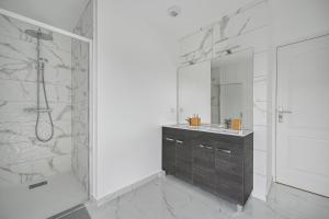 a bathroom with a shower and a sink and a mirror at Casa di Luce - Garden - 9 people - Close to La Défense in Bezons +26 photos