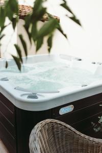 a hot tub sitting next to a chair at História Présház boutique Nagyréde in Gyöngyös