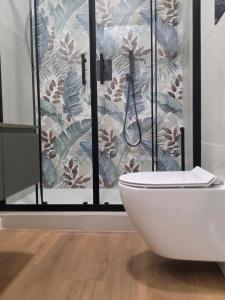 a bathroom with a toilet in front of a shower at Amuri Holiday Home in Agrigento +136 photos