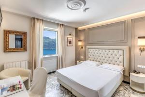 a bedroom with a white bed and a window at Hotel Castel Vecchio in Castel Gandolfo +79 photos