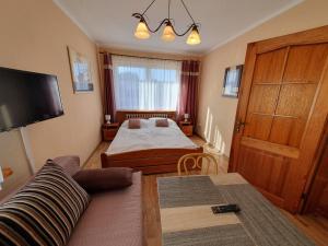 a living room with two beds and a couch at Willa Zuza in Kołobrzeg