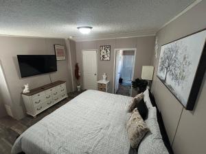 a bedroom with a bed and a flat screen tv at Cozy river front lookout in Bullhead City