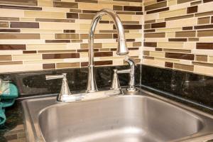a kitchen sink with a faucet on top of it at Hi Country Haus Unit 0406 in Winter Park