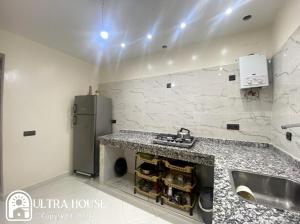 a kitchen with a counter and a sink and a refrigerator at Prime Location, Budget Friendly Studio in Central 