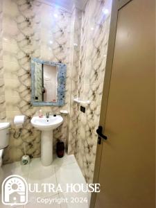 a bathroom with a sink and a mirror at Prime Location, Budget Friendly Studio in Central 