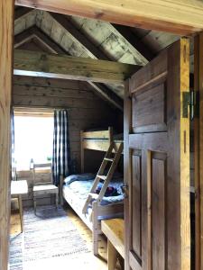 an attic room with a bunk bed and a ladder at Stall Rygg Mountain Cottage, Gloppen in Rygg +12 photos
