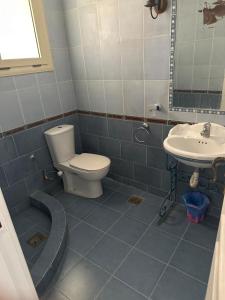 a bathroom with a toilet and a sink at Superior Chalet Marina 4 in El Alamein +30 photos