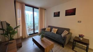 a living room with a couch and a table at Oceana Suites Eco Costas in Concón