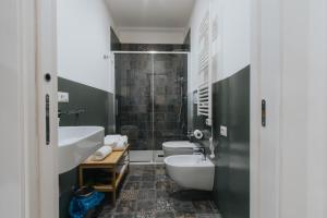 a bathroom with two toilets and a sink at Dimora Favia in Bari