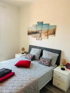 a bedroom with a bed with red pillows on it at Casa Red Riviera in Juan-les-Pins