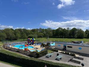 an amusement park with a pool and a playground at Charmant Mobil-home 3 chambres de Valérie et Hermann Camping 4 étoiles in Clohars-Carnoët +9 photos