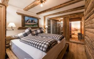 zwei Betten in einem Zimmer mit Holzwänden in der Unterkunft Hotel Bergschlössl in Lüsen + 115 Fotos
