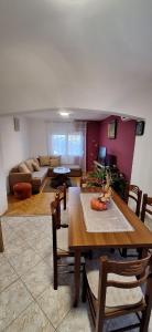 a living room with a table and a couch at Apartments Aurora in Bar