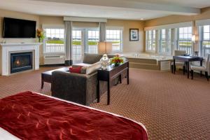 a large living room with a couch and a fireplace at Comfort Suites Chincoteague Island Bayfront Resort in Chincoteague