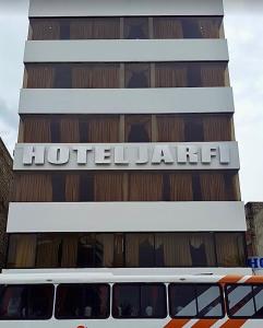 a bus is parked in front of a hotel at Hotel Jarfi in Hacienda El Recreo