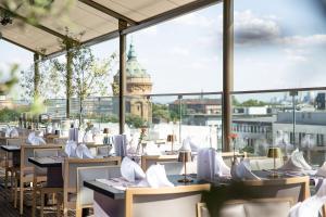 a restaurant with a view of the clock tower at Radisson Blu Hotel, Mannheim in Mannheim
