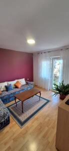 a living room with two beds and a coffee table at Apartments Aurora in Bar