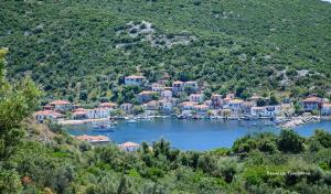 a town on a lake with boats in the water at Dimitris house in Ayía Kiriakí