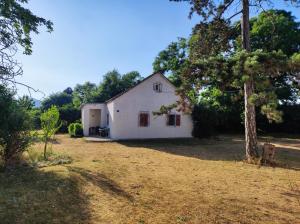 a white house in the middle of a yard at Old house in Nikšić