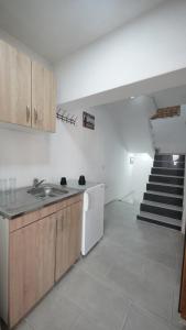 a kitchen with a sink and a staircase at Hattuşa Hostel in Prizren +54 photos