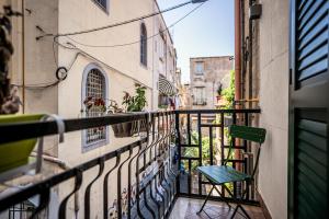 a balcony with a green chair on a building at Experience Napoli Center in Naples