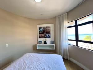 a bedroom with a bed and a large window at Elegance Comfort Natal Beira Mar in Natal +45 photos