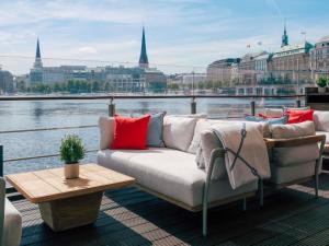 a couch sitting on the deck of a boat at Fairmont Hotel Vier Jahreszeiten in Hamburg