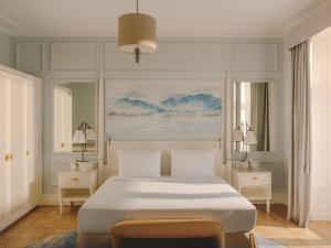 a bedroom with a large white bed with two tables at Fairmont Le Montreux Palace in Montreux