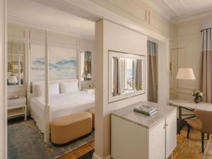 a hotel room with a bed and a desk with a desk at Fairmont Le Montreux Palace in Montreux